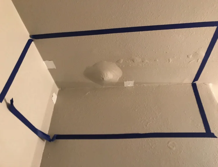 IMG_4182 Corner of a ceiling and wall with drywall repairs taped for patching